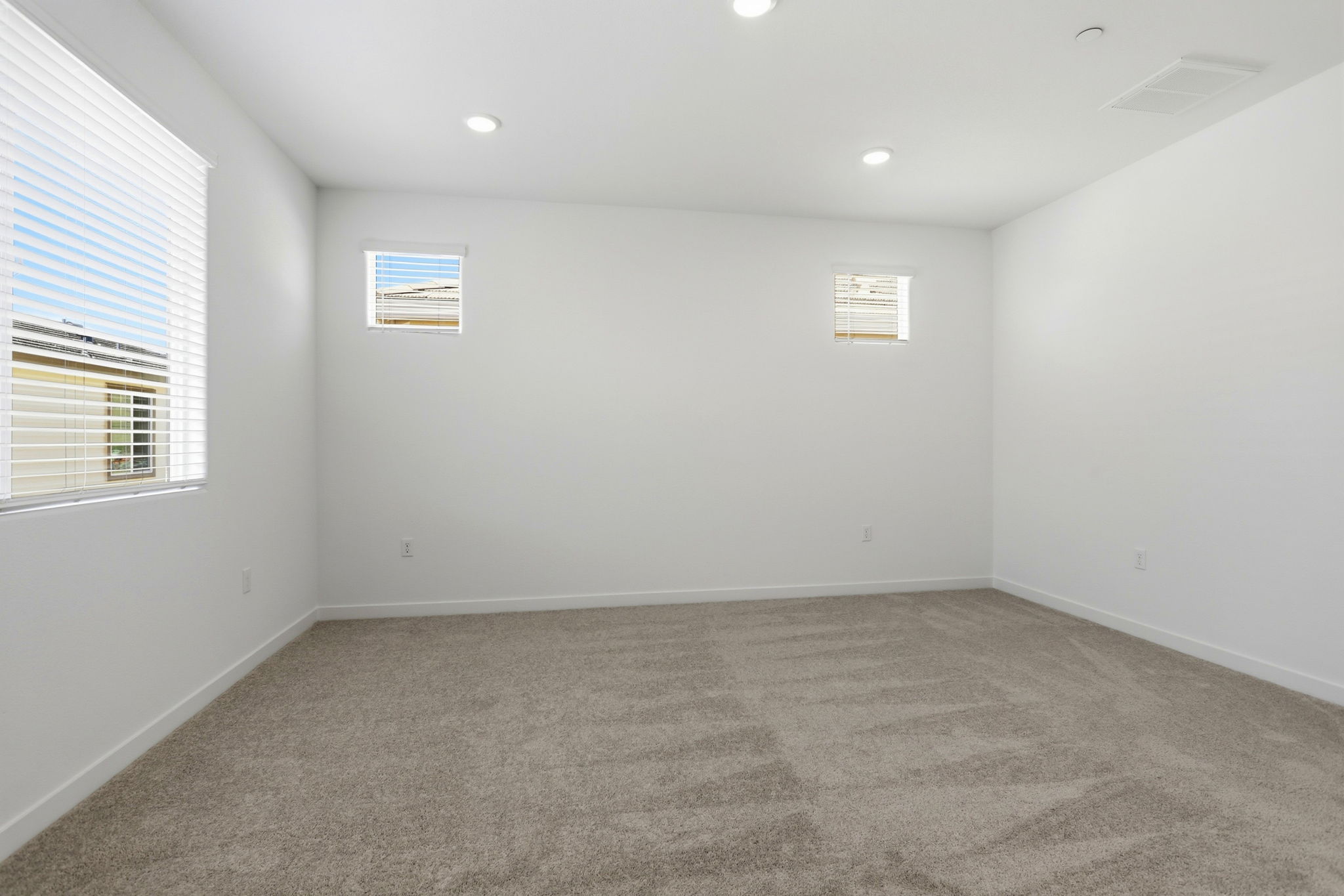 A room with a carpet and a window.