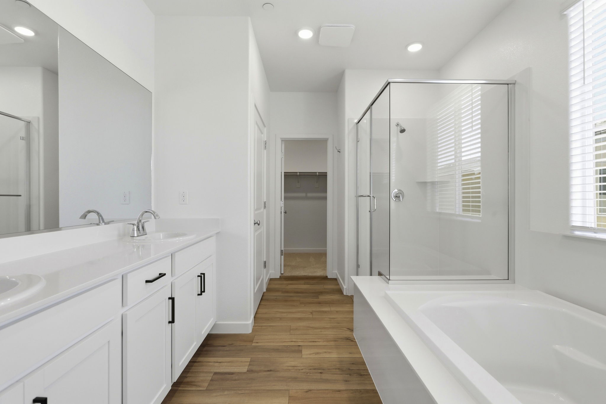 A bathroom with white cabinets.