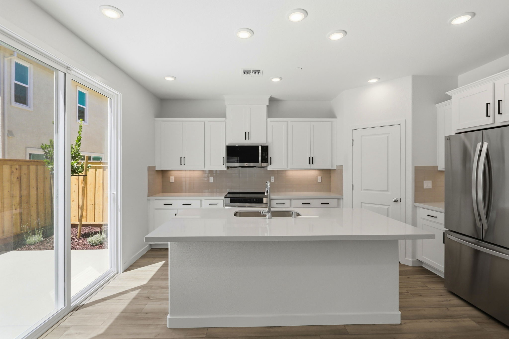 A kitchen with white cabinets.