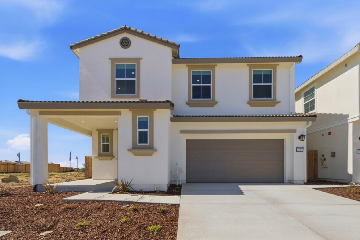A white house with a garage.