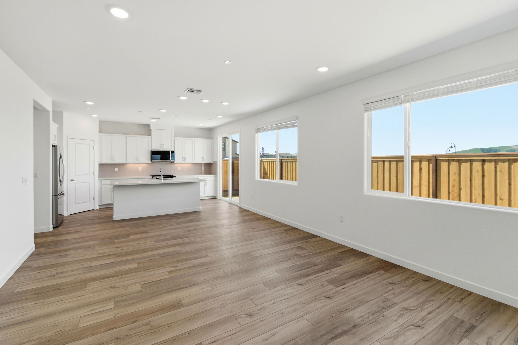 A large kitchen with white walls.