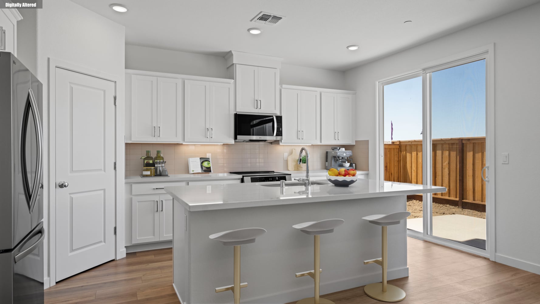 A kitchen with white cabinets.
