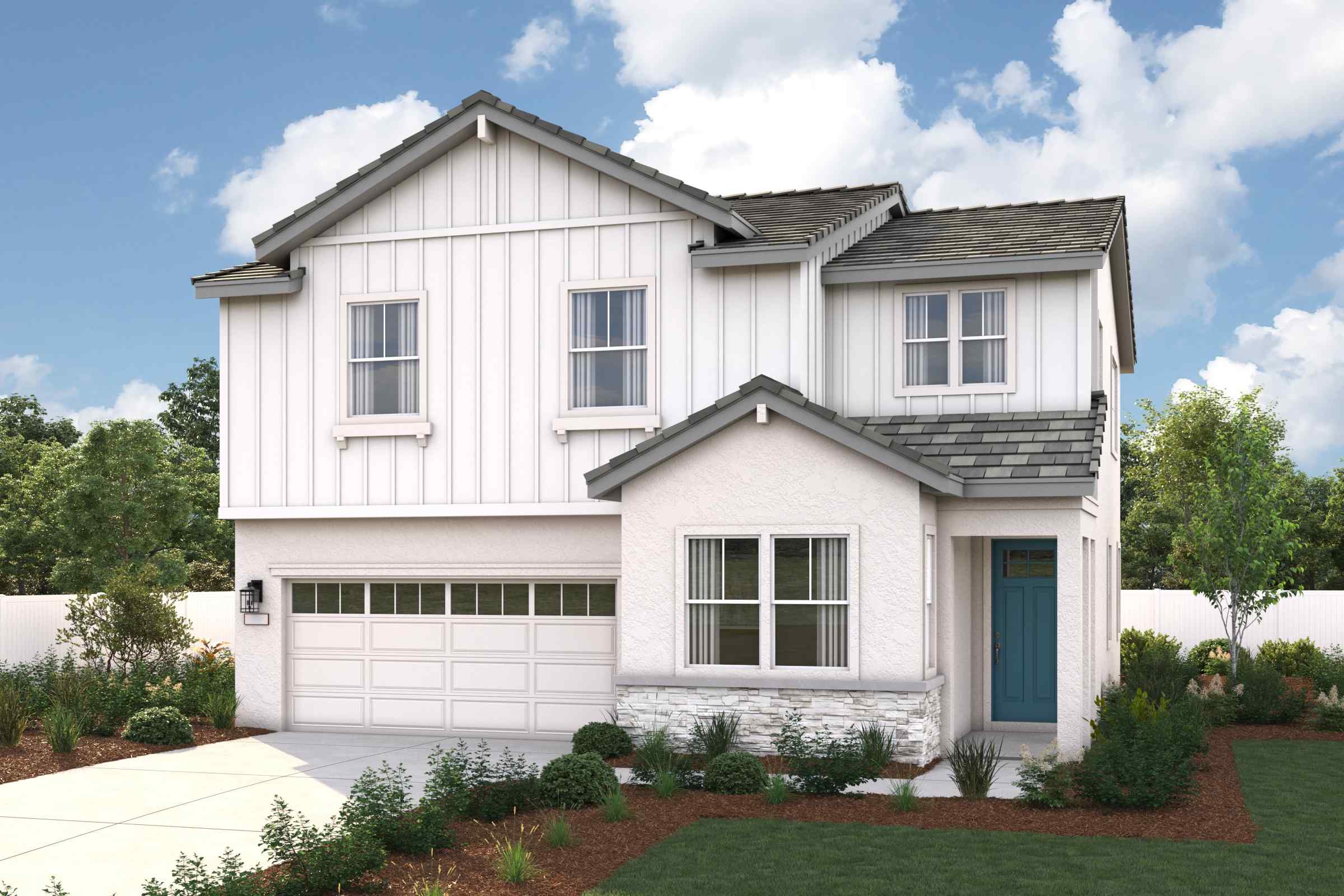 A white house with a green lawn.