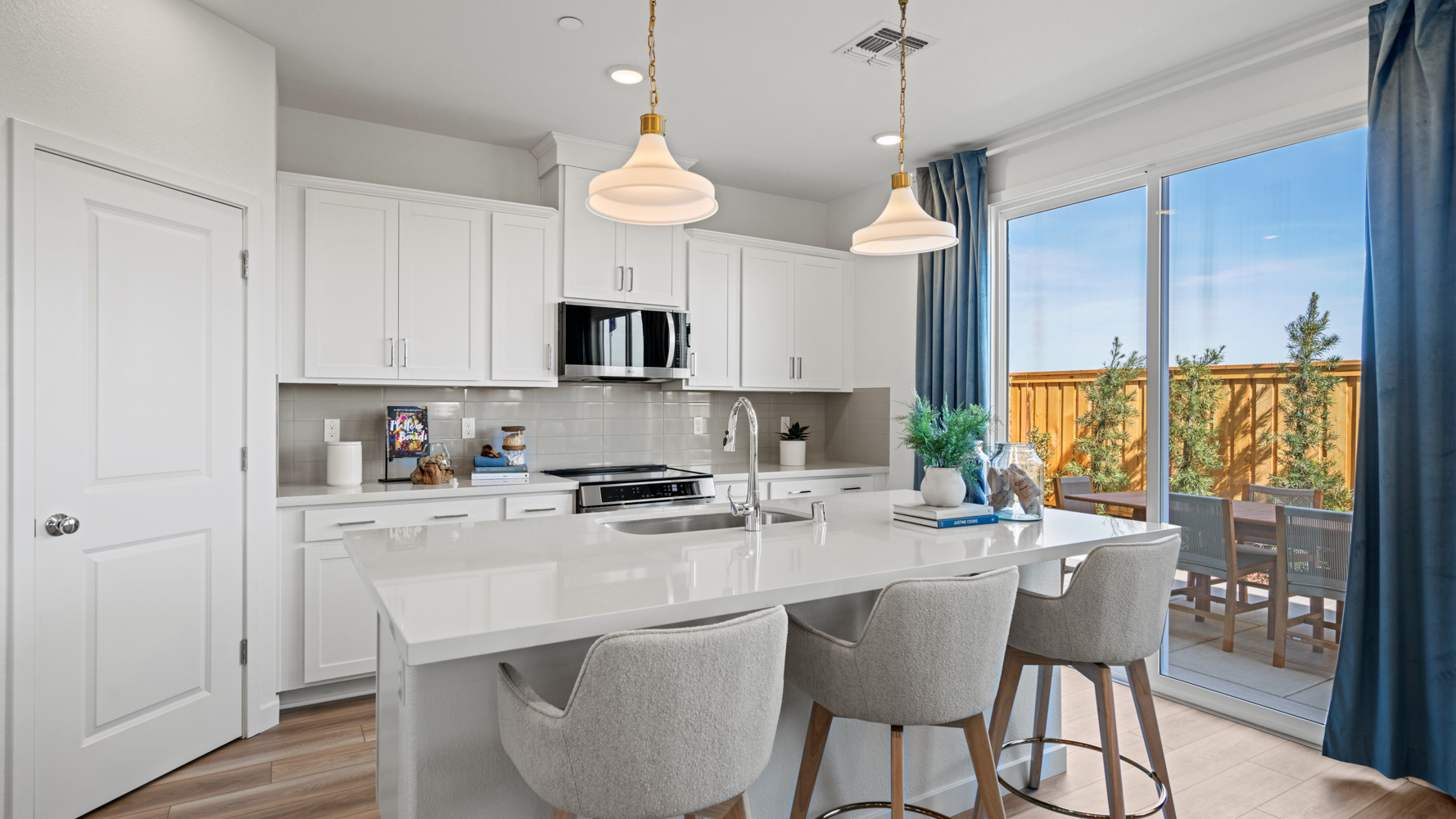 A kitchen with white cabinets.