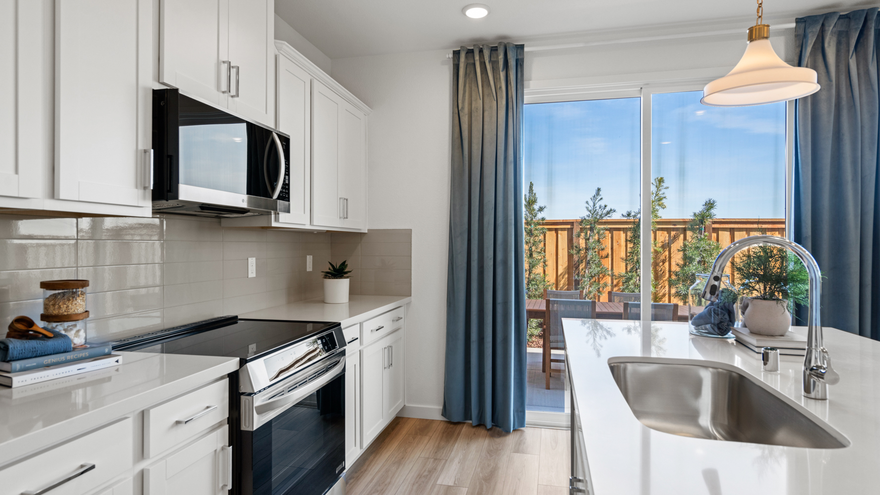 A kitchen with white cabinets.