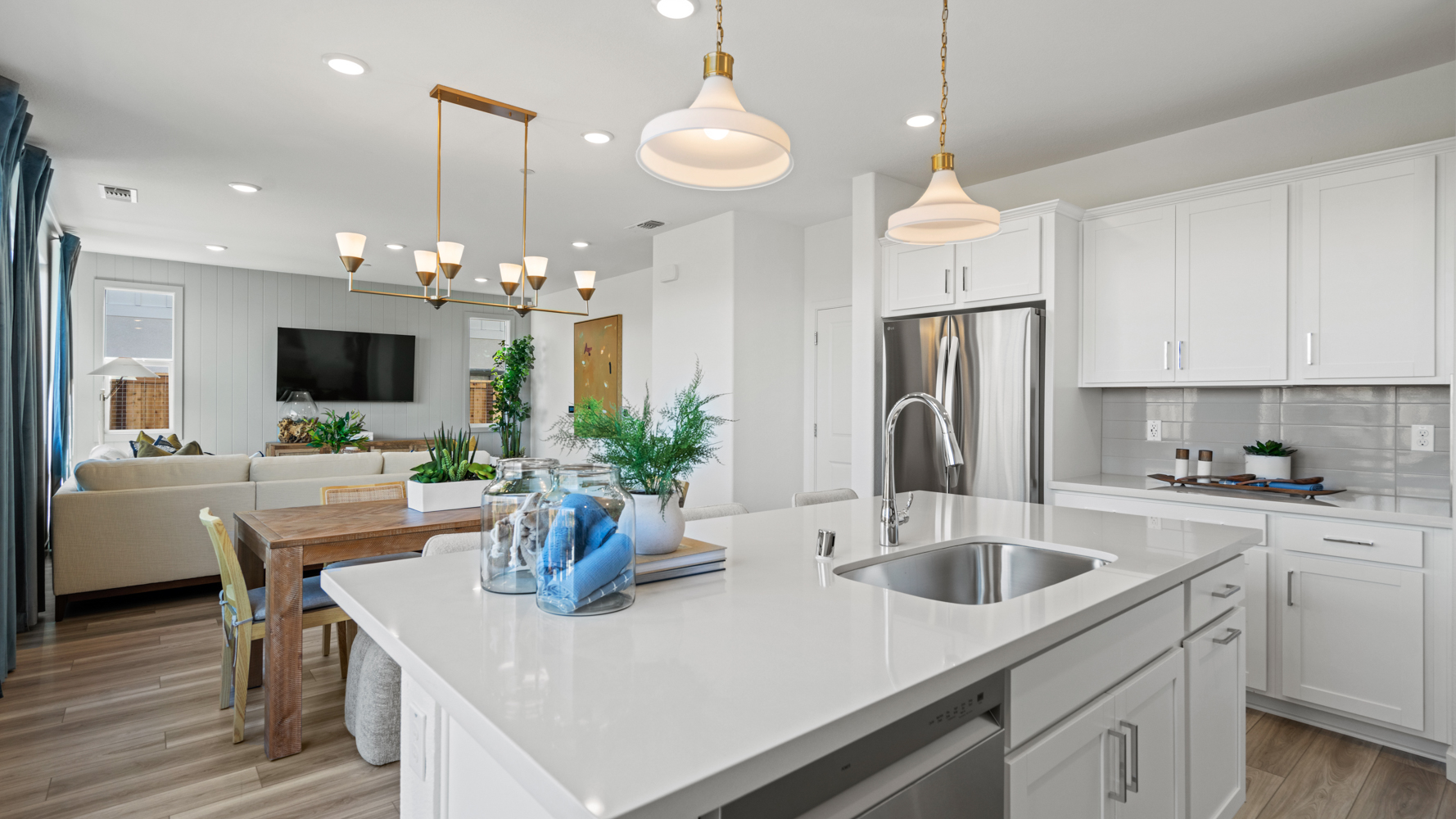 A kitchen with white cabinets.