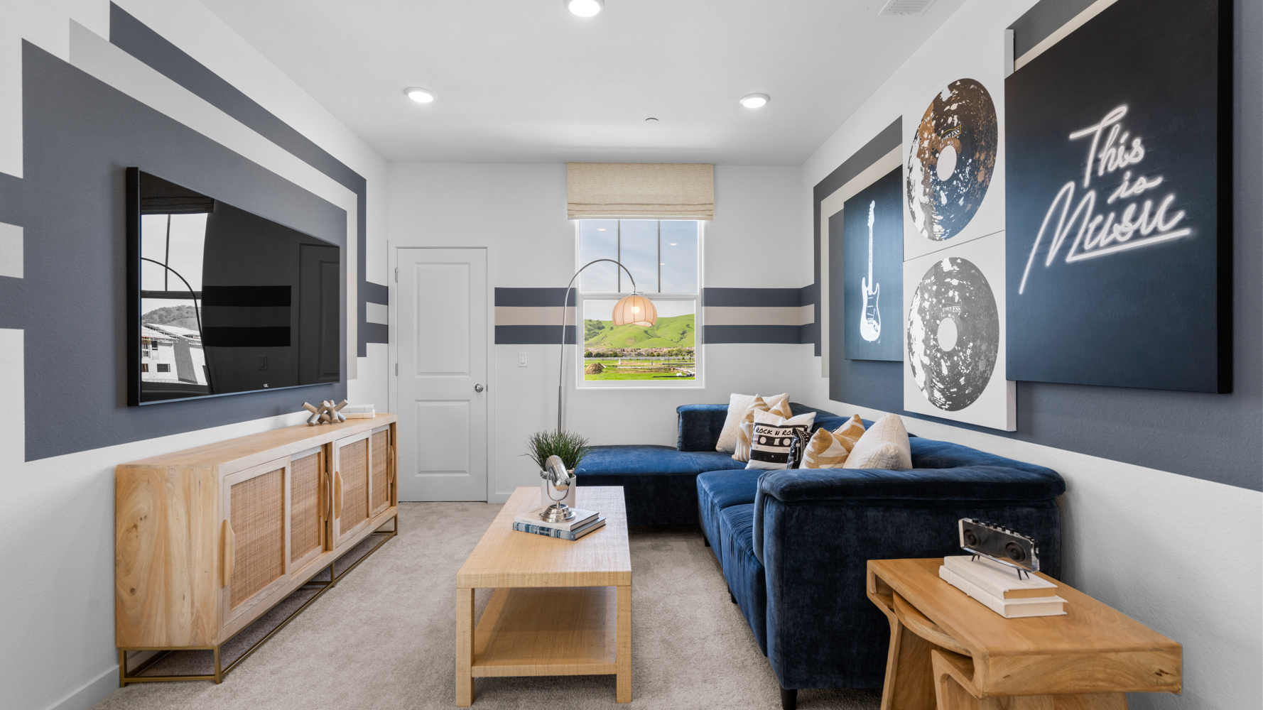 A living room with a blue couch.