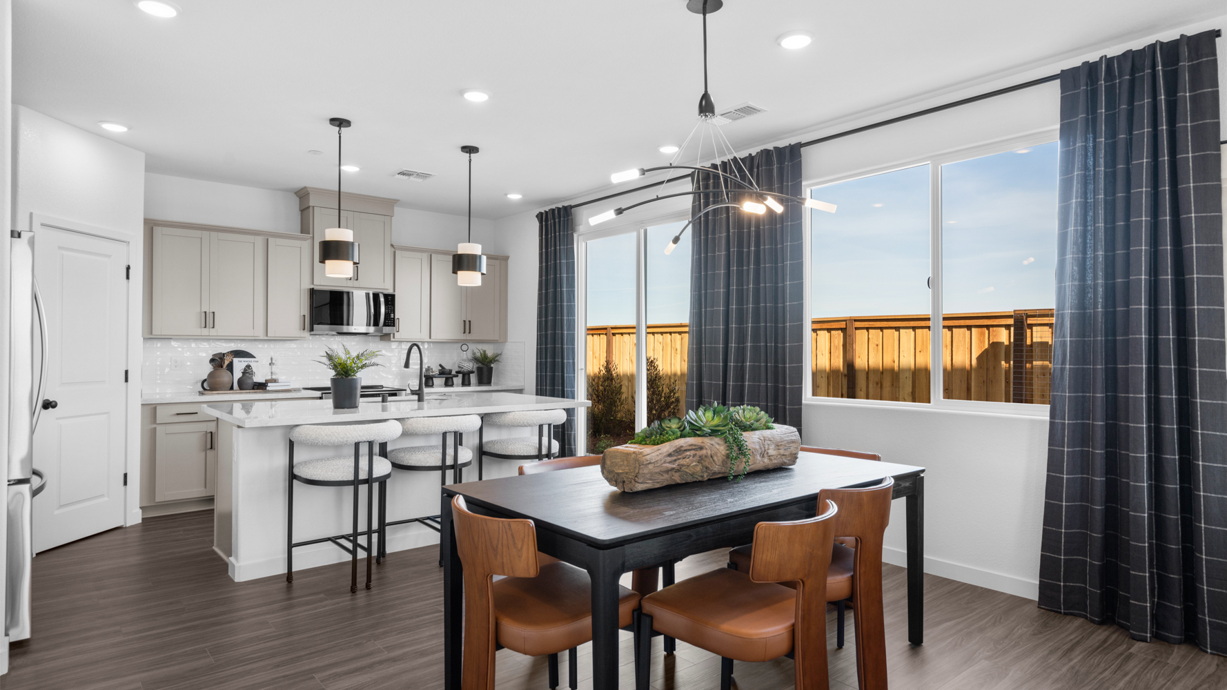 A kitchen with a table and chairs.