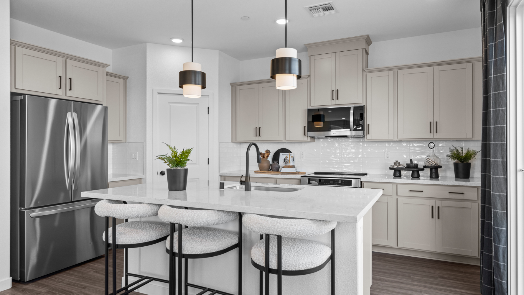 A kitchen with white cabinets.