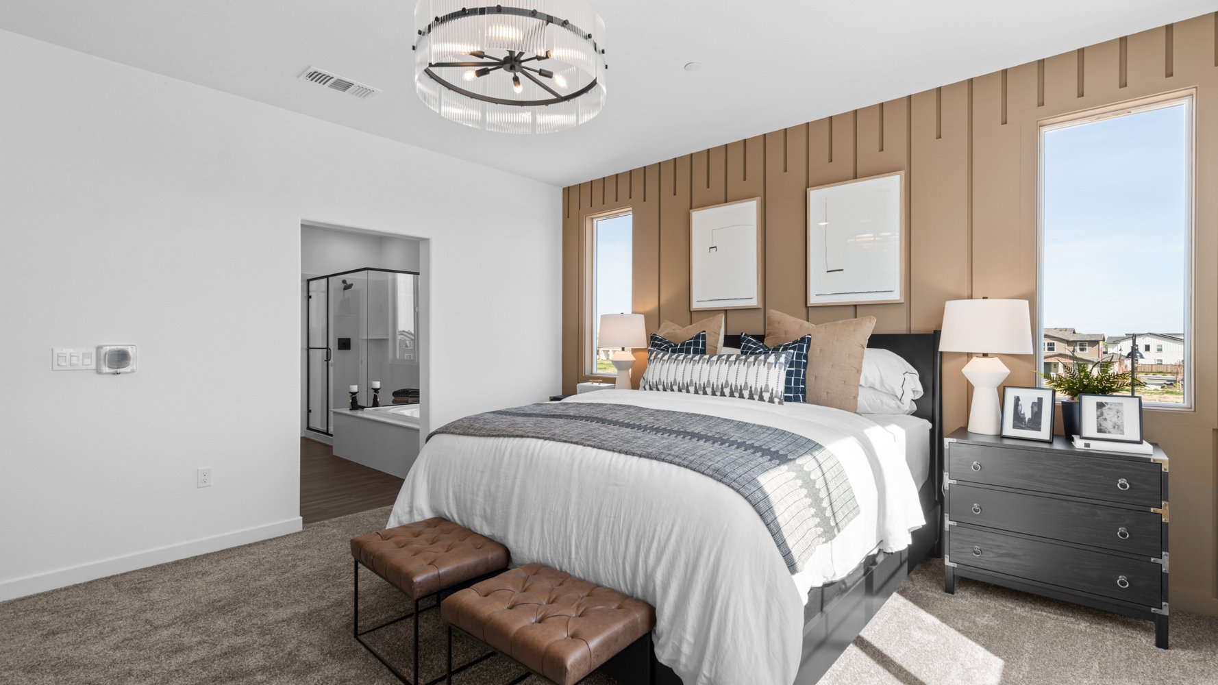 A bedroom with a bed and a fan.