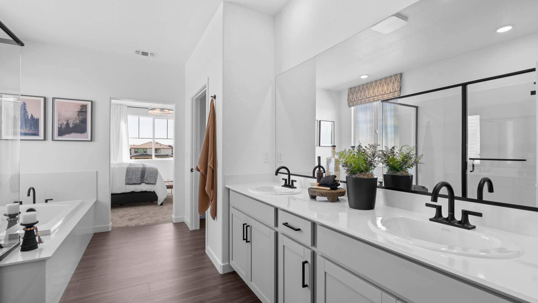A bathroom with a tub sink and a mirror.