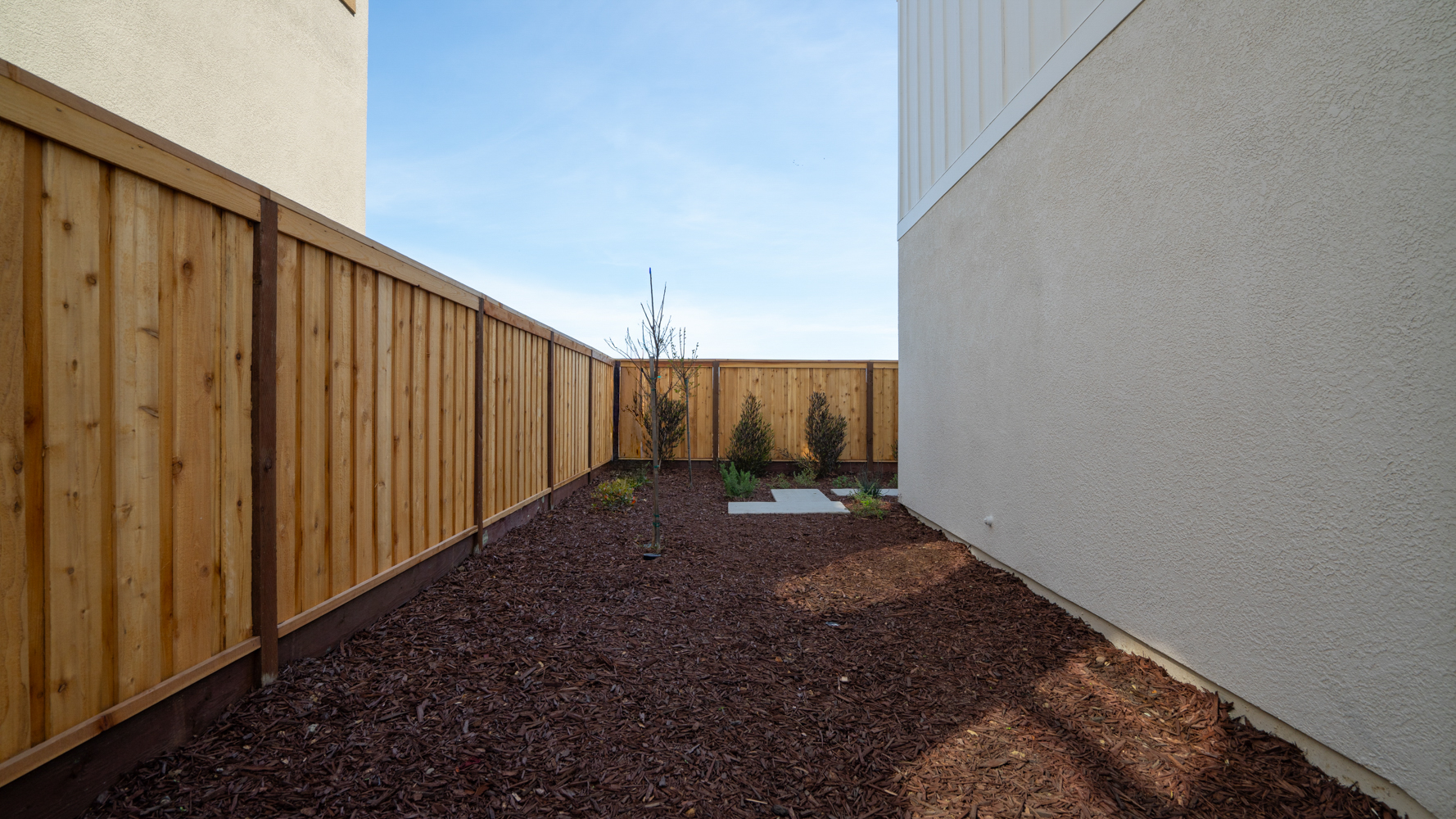 A dirt path between two wooden buildings.