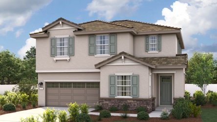 A house with a garage and a lawn in front of it.
