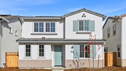 A white house with blue doors.