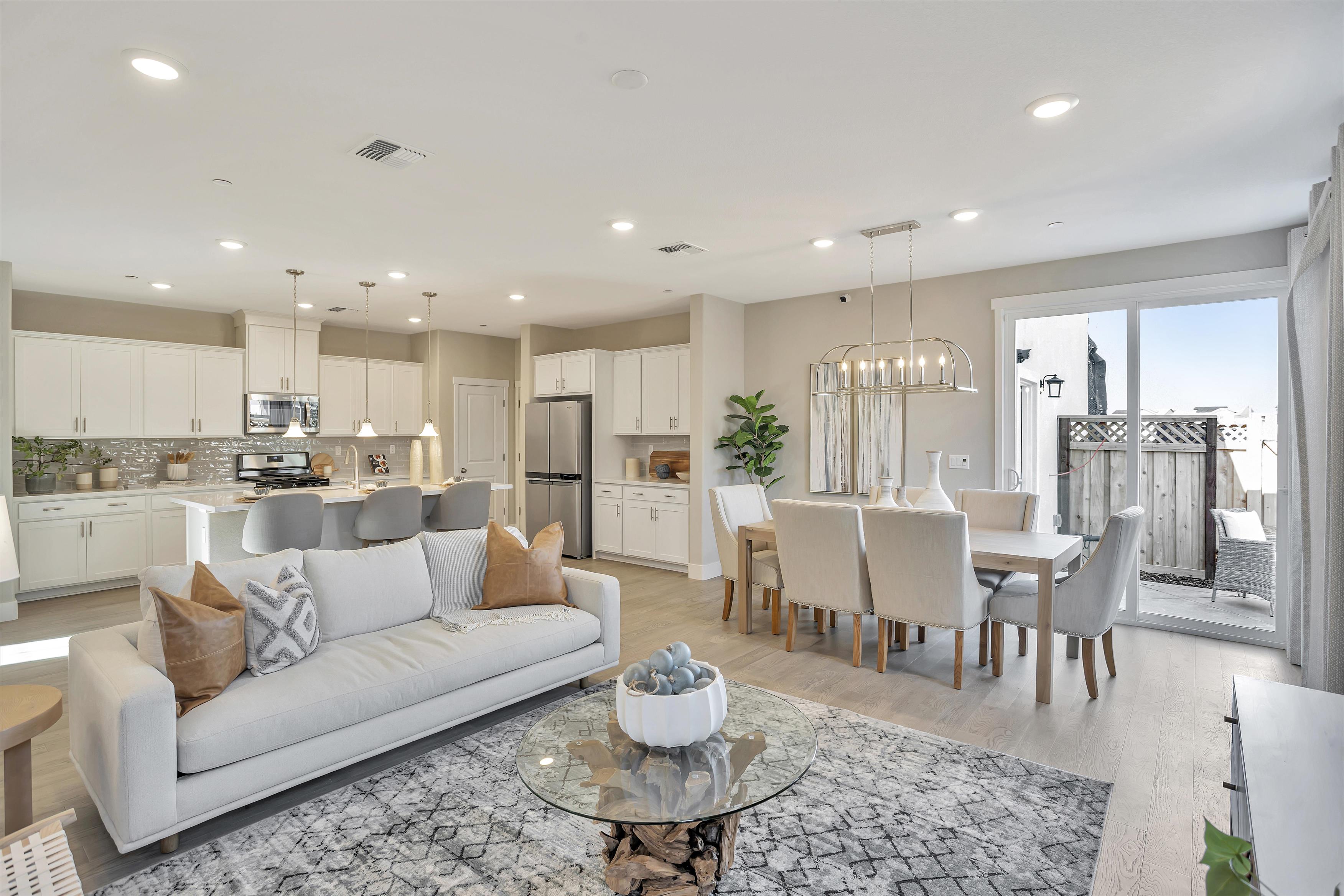 A large living room with a couch and a dining table.