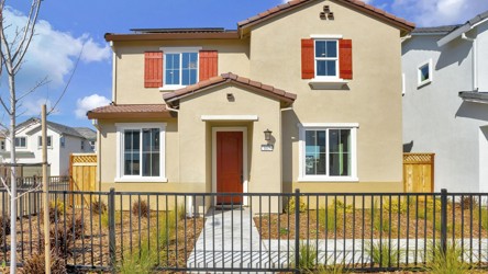 A white house with red shutters.