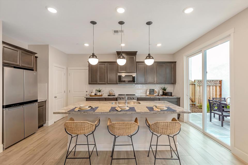 A kitchen with a bar and island.