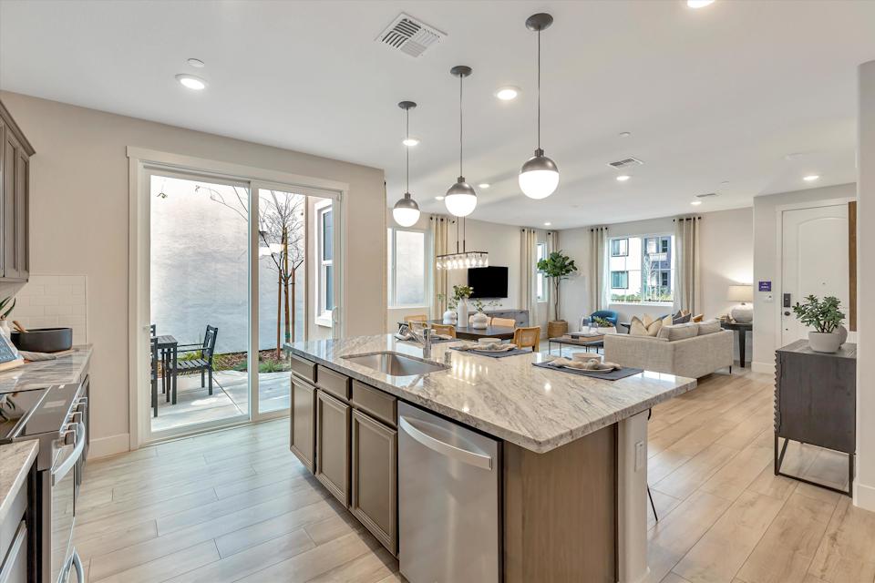 A kitchen with a marble island.