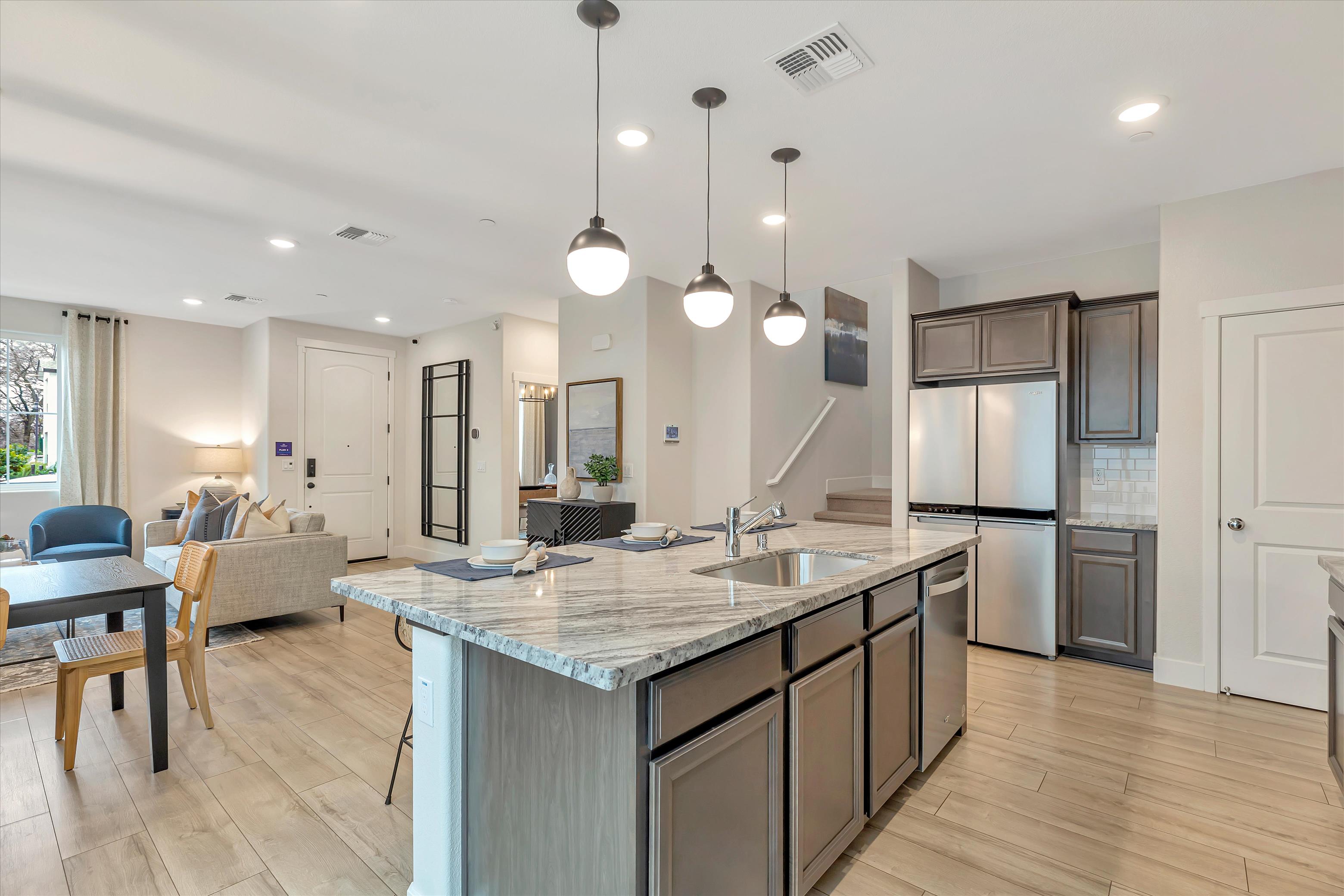 A kitchen with a bar and island.