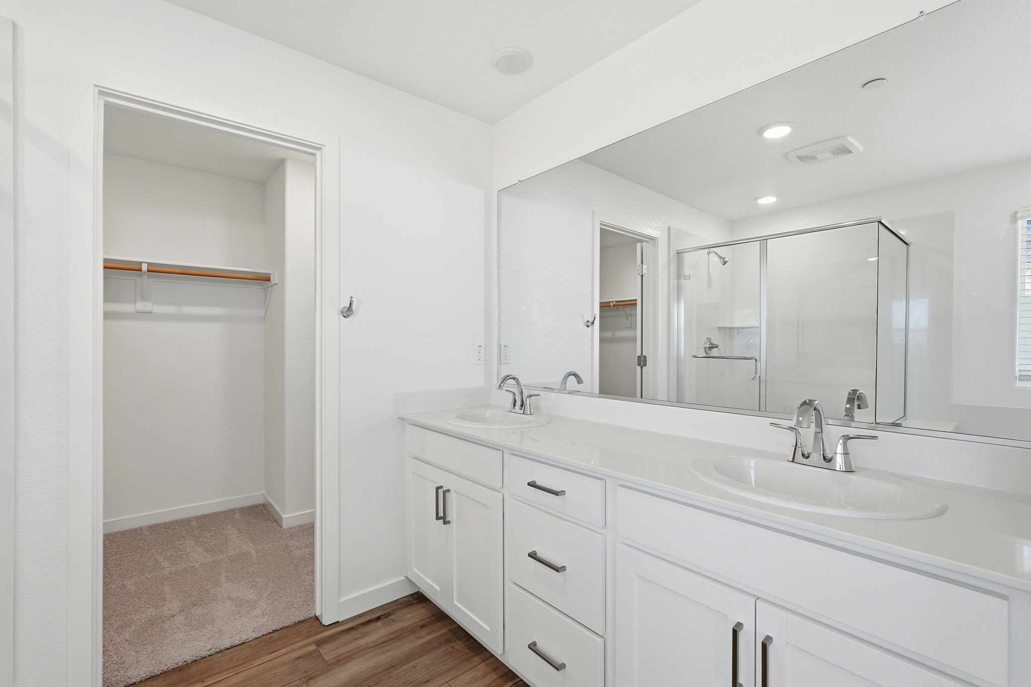 A bathroom with a large mirror.