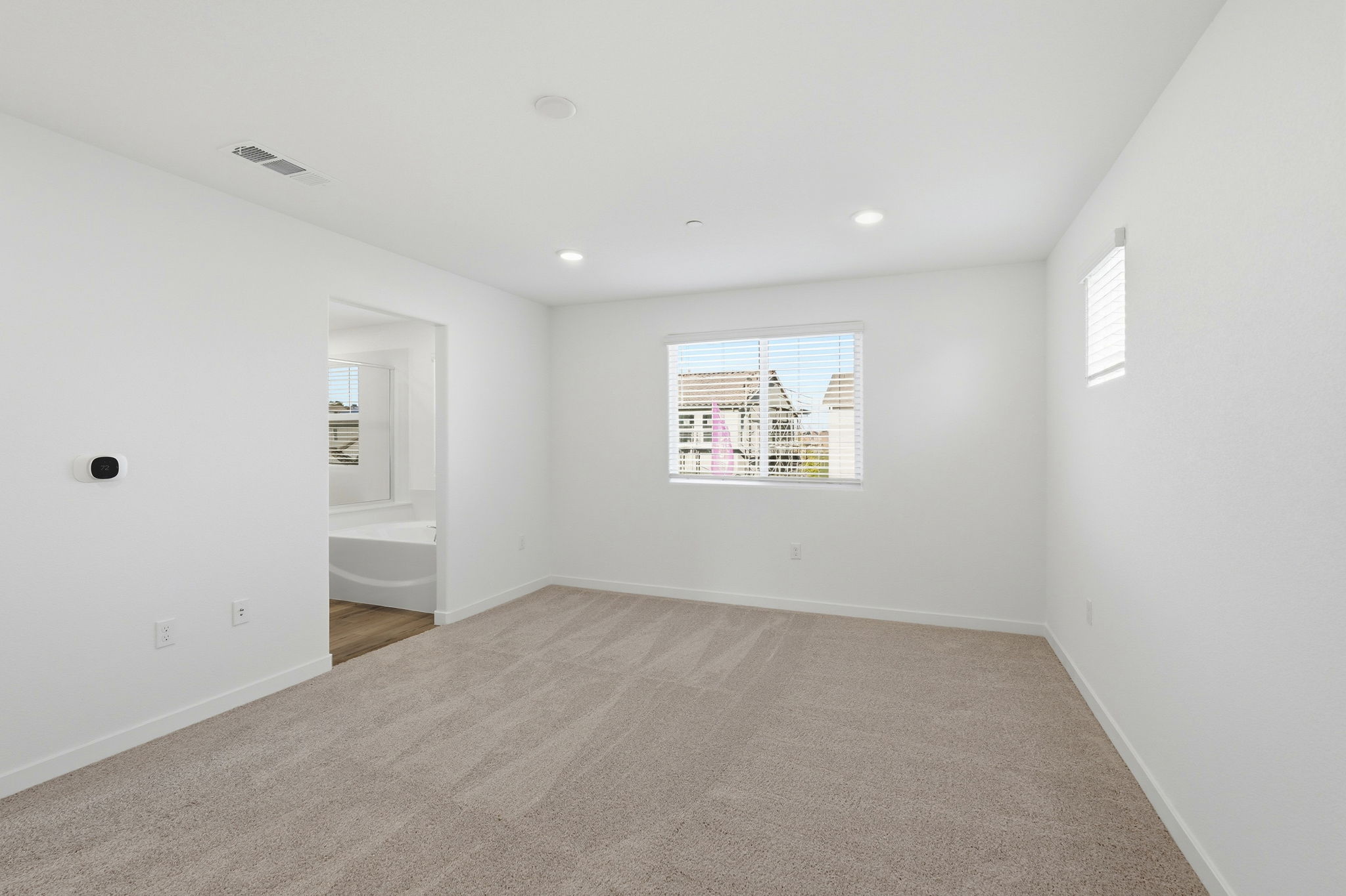 A room with a bed and a window.