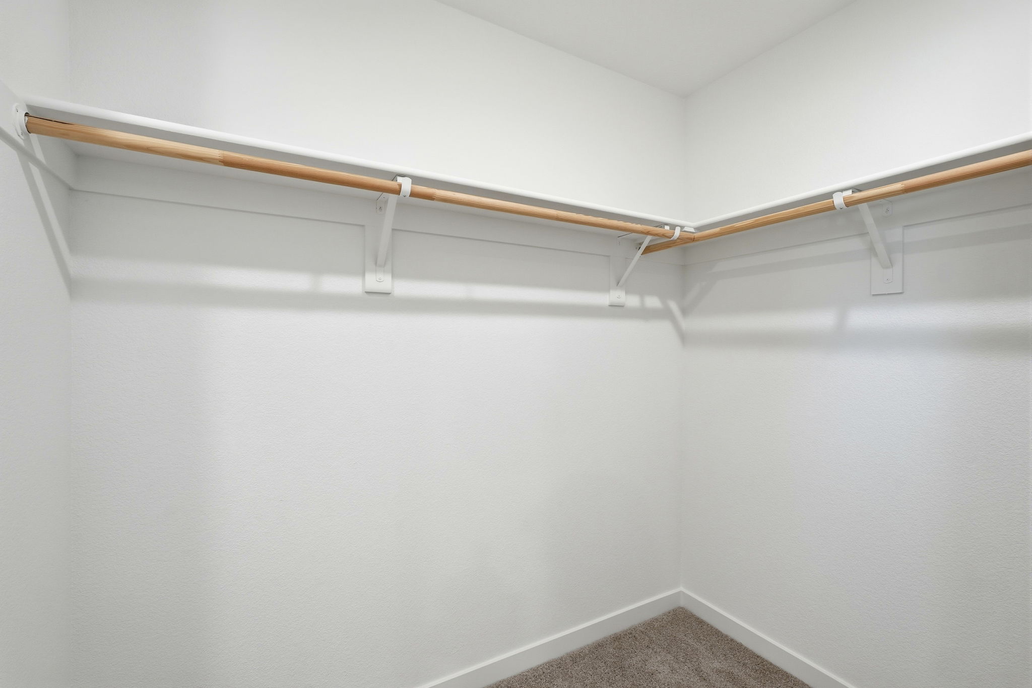 A white wall with a wooden railing.