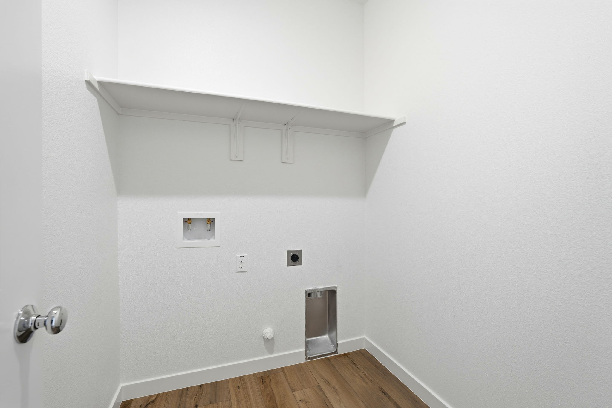 A white wall with a light fixture.