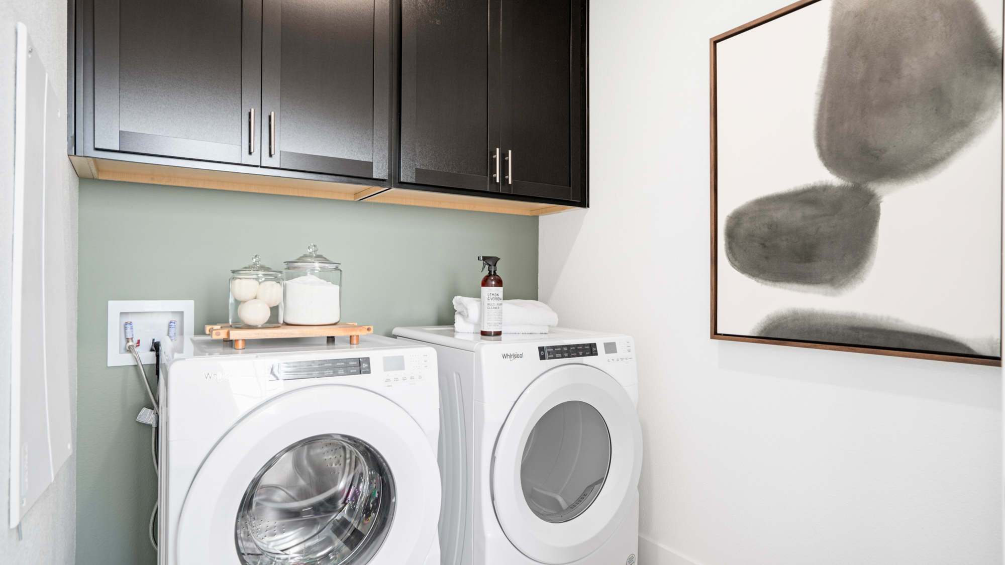 A washing machine and a dryer in a room.