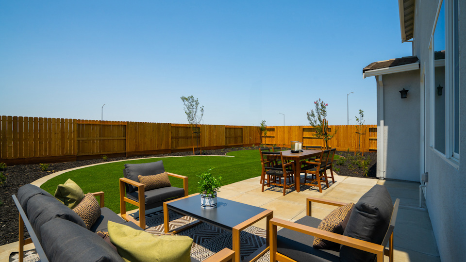 A patio with a table and chairs.