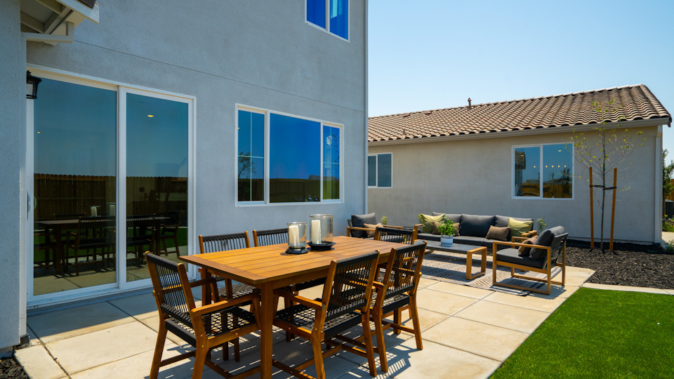 A table and chairs on a deck.