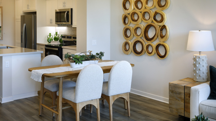 A dining room with a table and chairs.