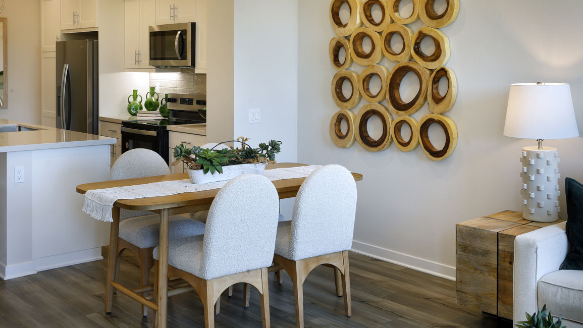 A dining room with a table and chairs.