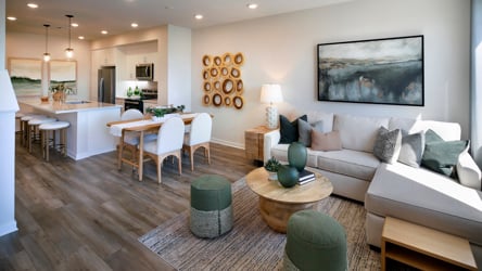 A living room with a large dining table and couches.