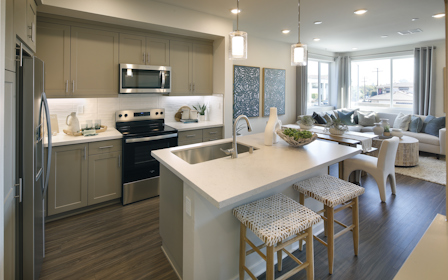 A kitchen with a bar stool and a bar stool.