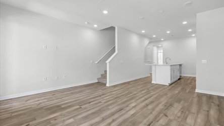A room with a wood floor and white walls.