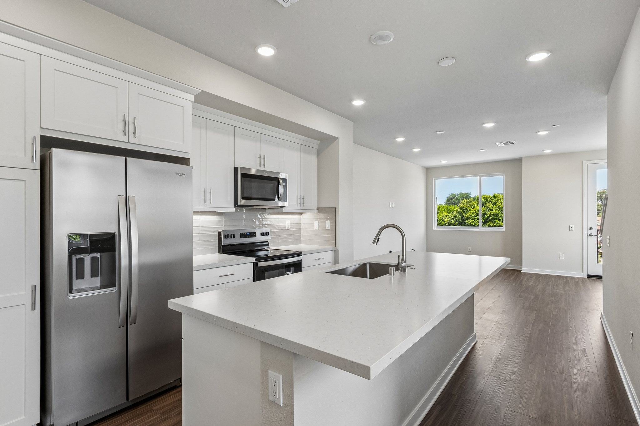 A kitchen with white cabinets.