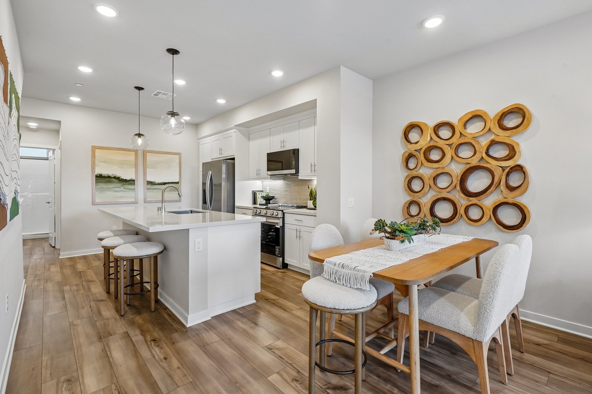 A kitchen with a dining table and chairs.