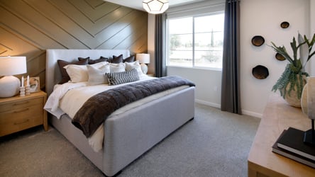 A bedroom with a bed and a desk.