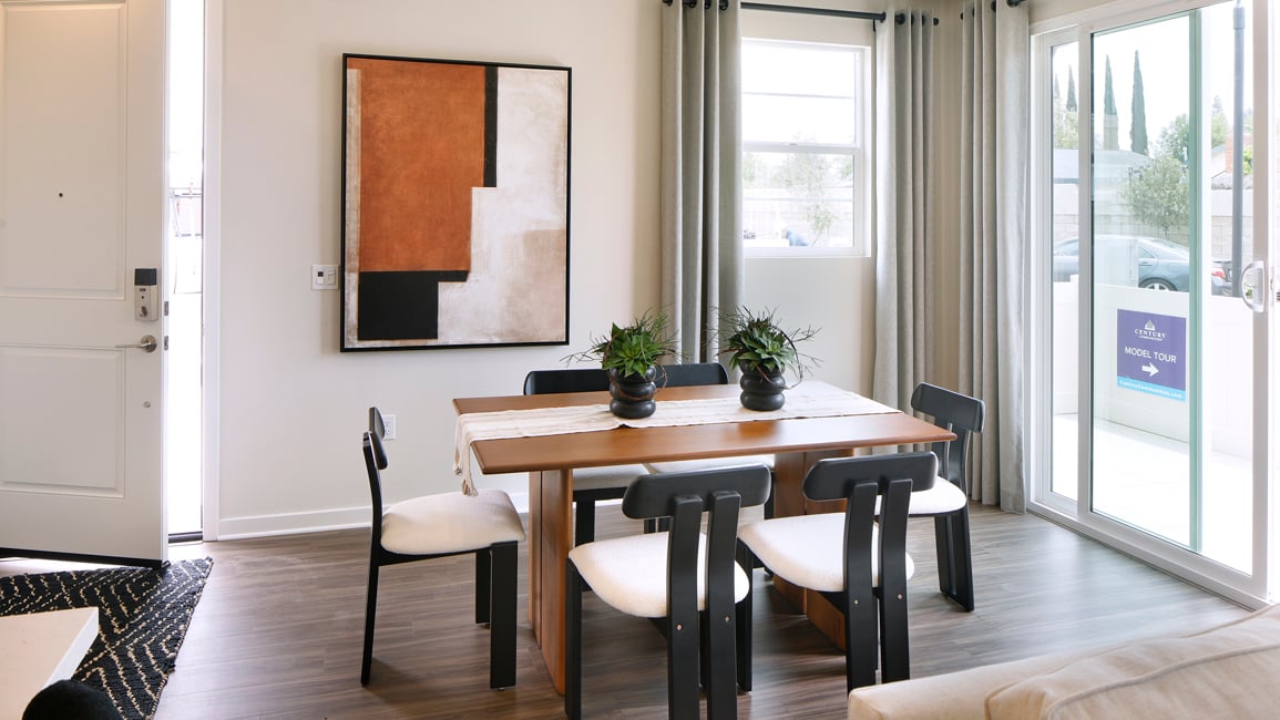 A room with a table and chairs.
