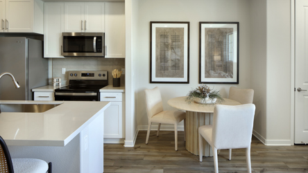 A kitchen with white cabinets.