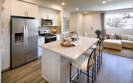 A kitchen with a dining table.