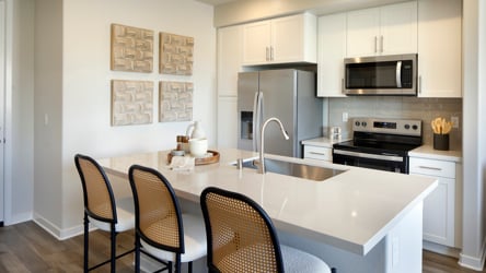 A kitchen with a table and chairs.