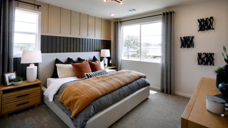 A bedroom with a bed and a desk.