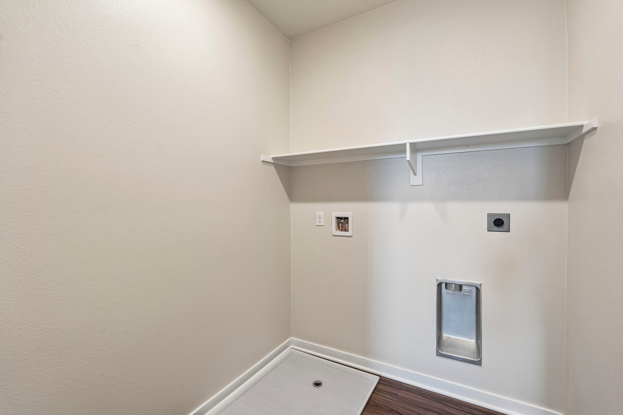 A white wall with a light on it.
