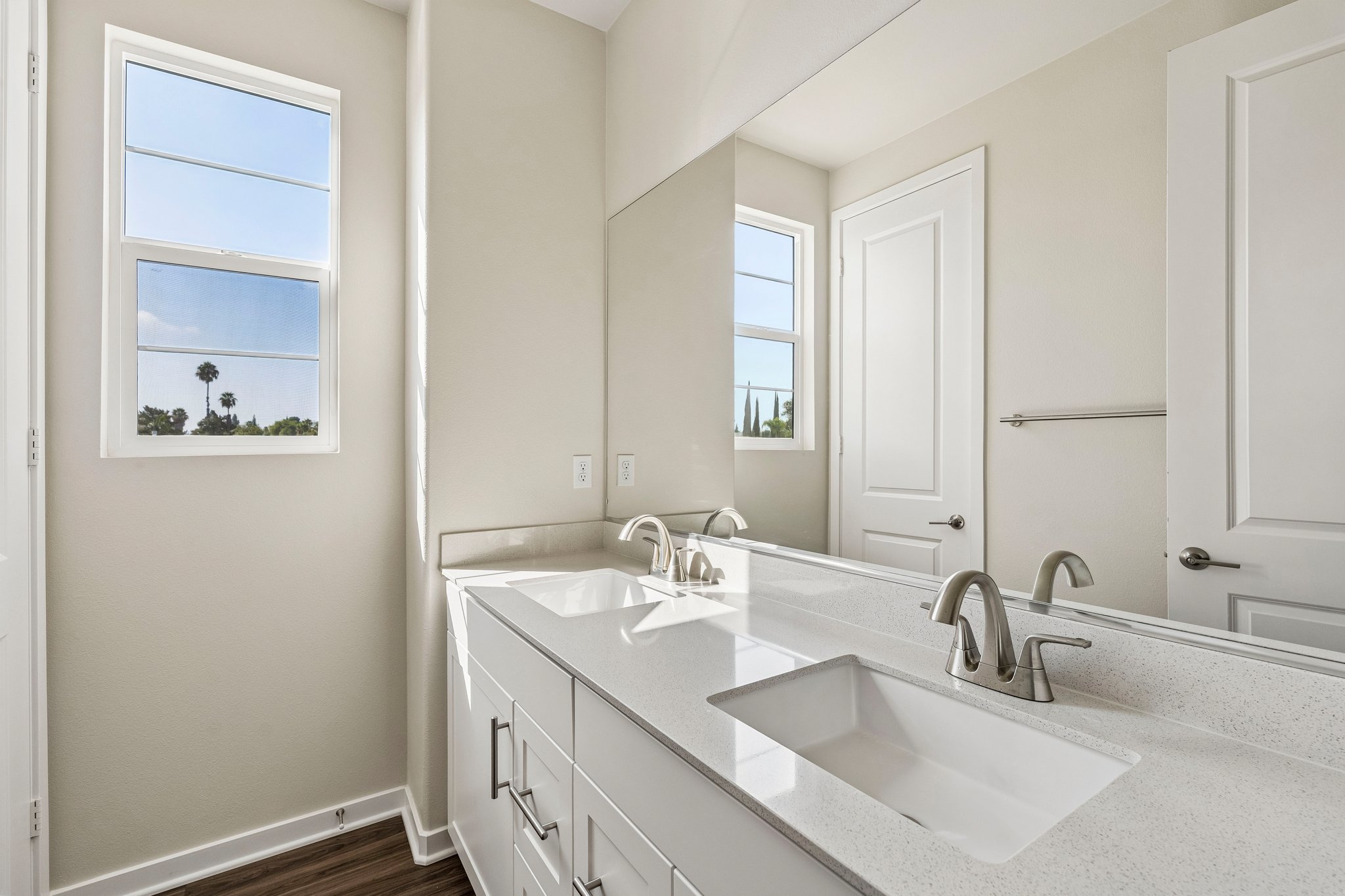 A bathroom with a large mirror.