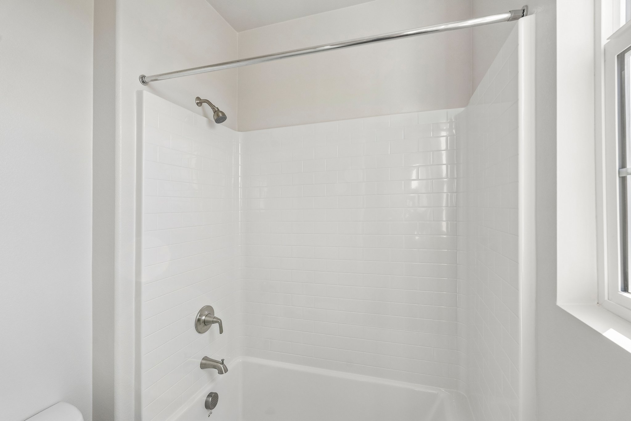 A bathroom with a shower unit.