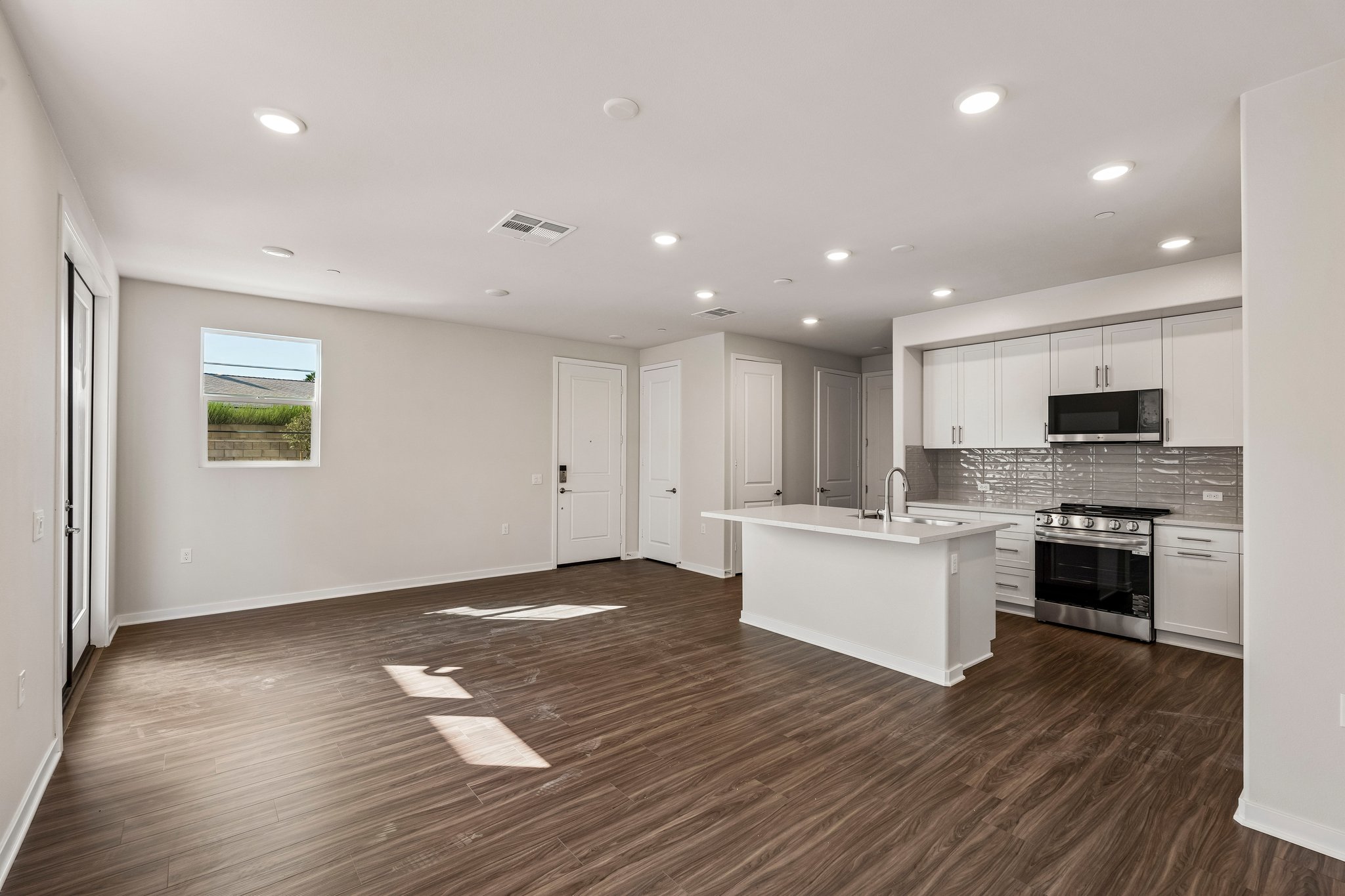 A kitchen with white cabinets.