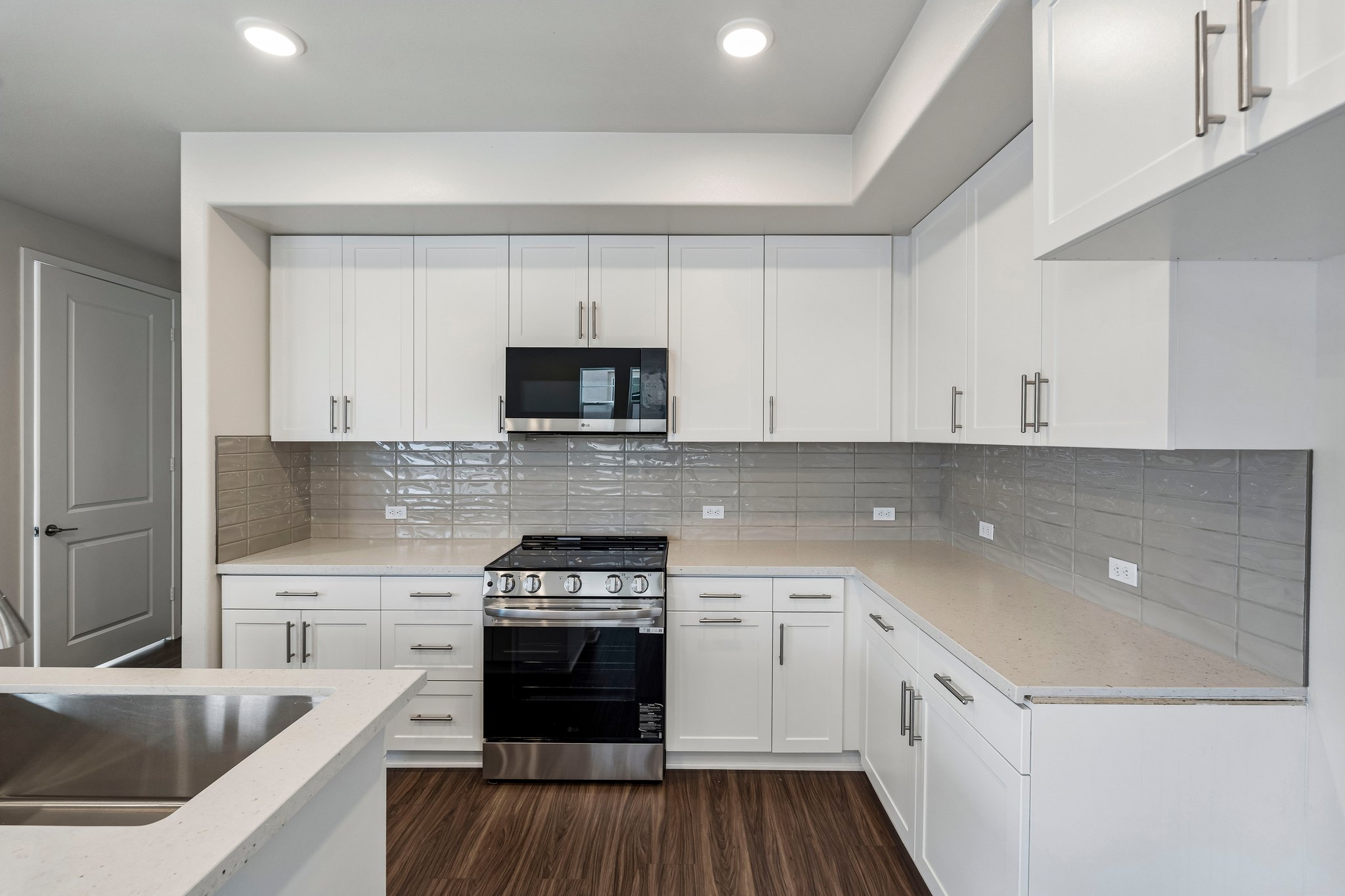 A kitchen with white cabinets.