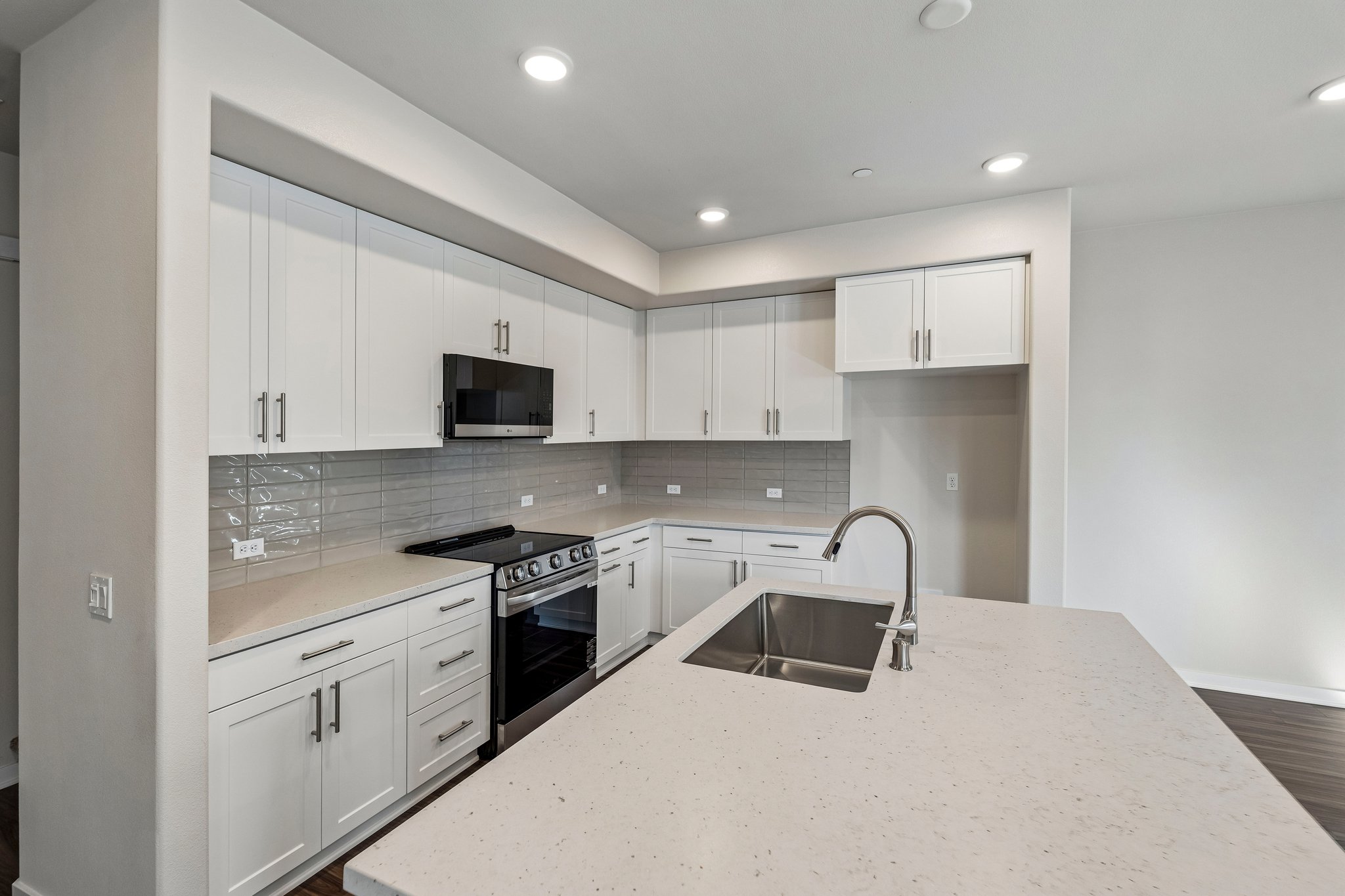 A kitchen with white cabinets.