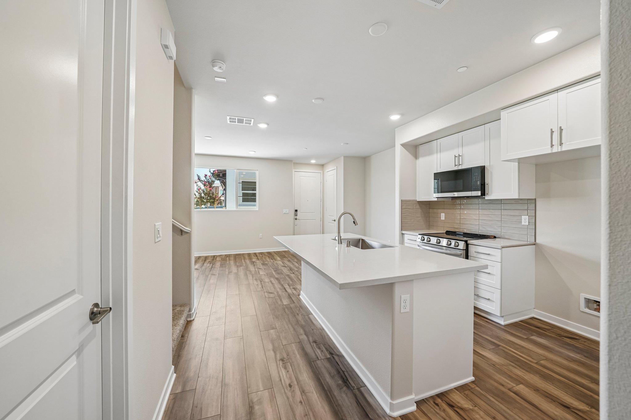 A kitchen with white cabinets.